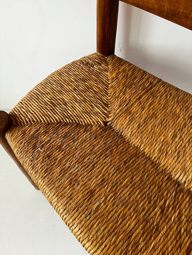 Old wooden and straw bench