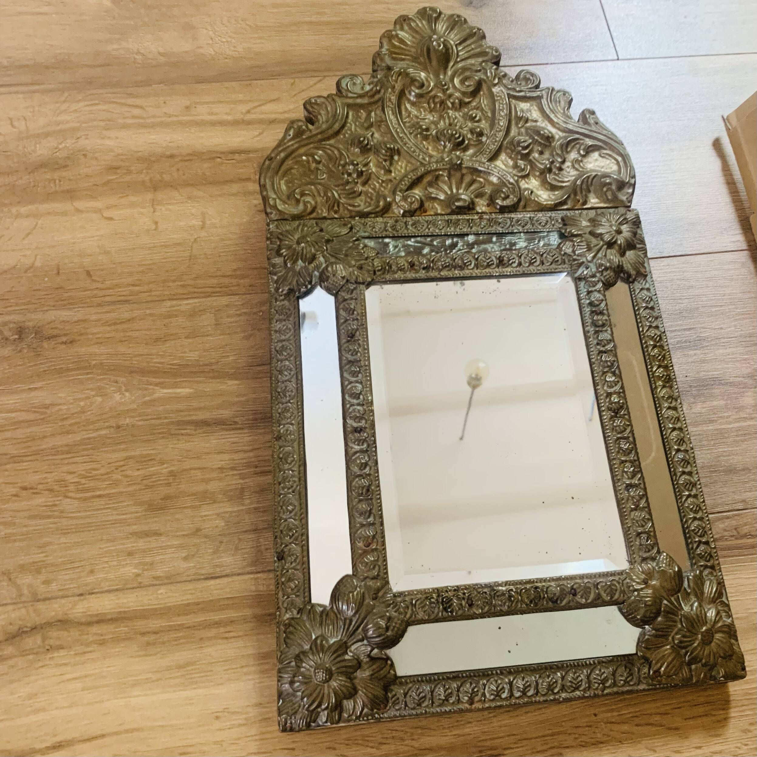 Small mirror with repoussé brass frame.