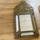 Small mirror with repoussé brass frame.