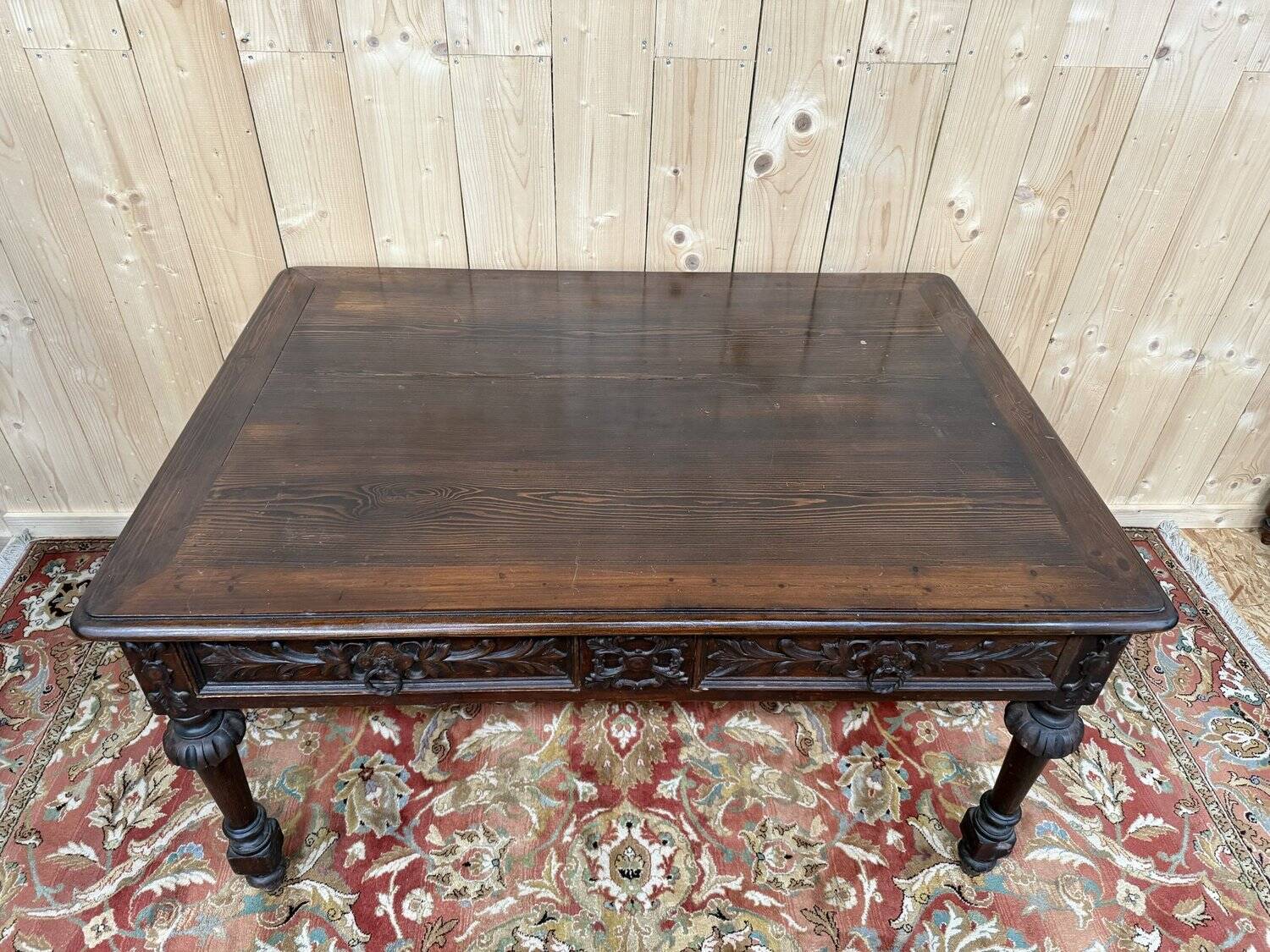 Middle table in a sculpted Louis XIII style living room.