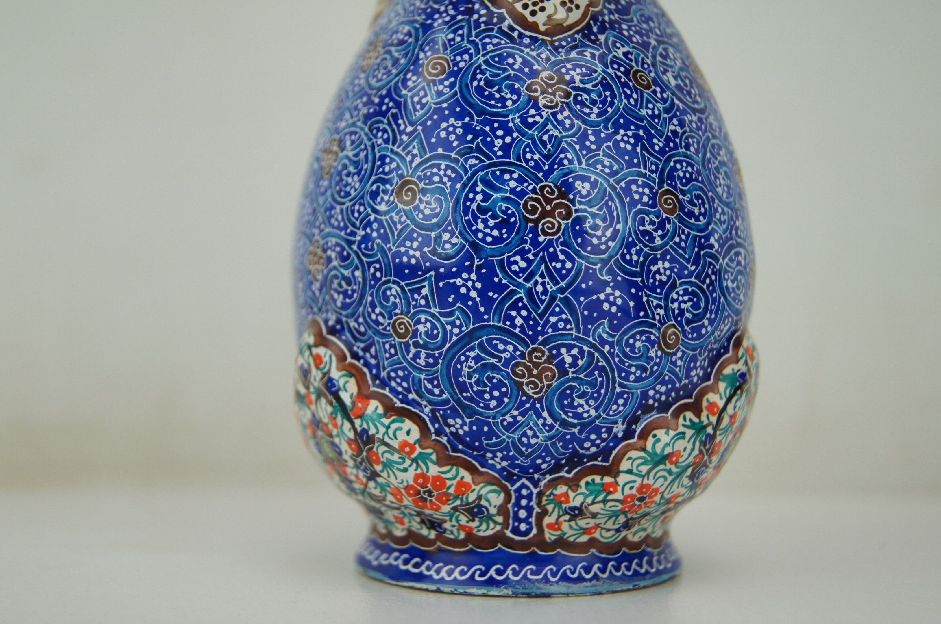 Piriform vase with a flared metal collar enamelled with a polychrome decoration, marked "Amini Iran" on the reverse.
