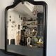 Miroir Napoléon III en bois noir à fronton