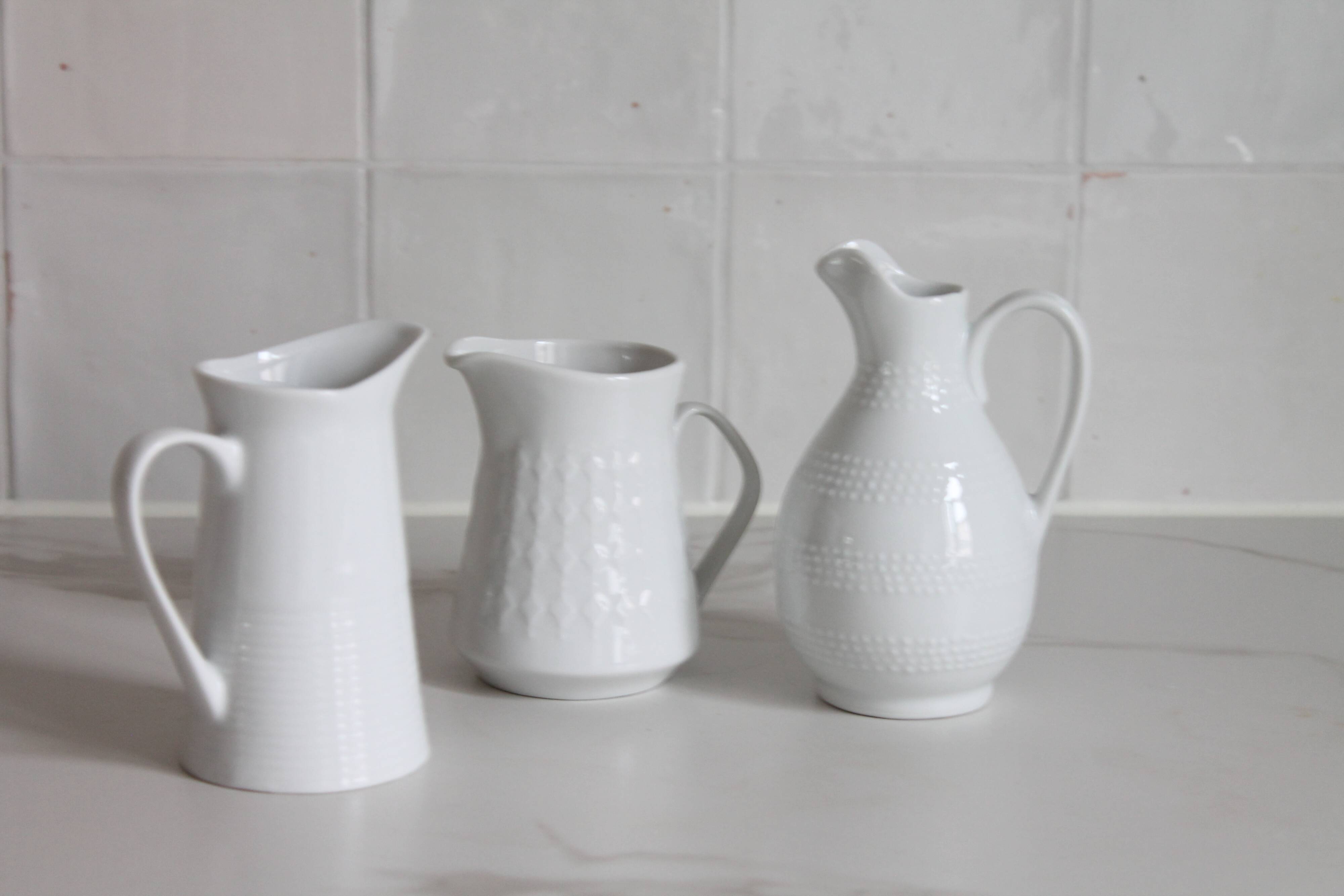 3 old French pitchers in white ceramic