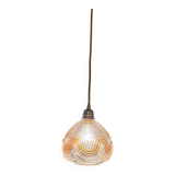 Suspension with amber moulded glass globe featuring wavy patterns.