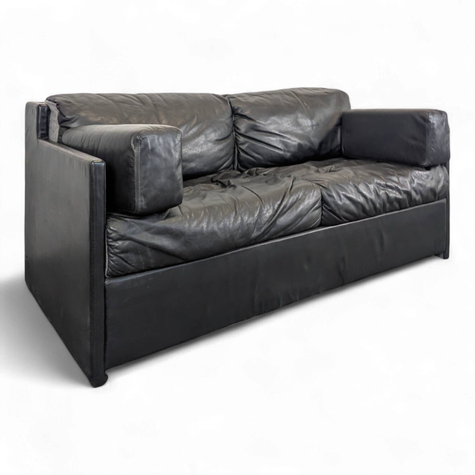 Black leather convertible sofa with goose feather upholstery.