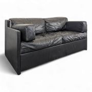 Black leather convertible sofa with goose feather upholstery.