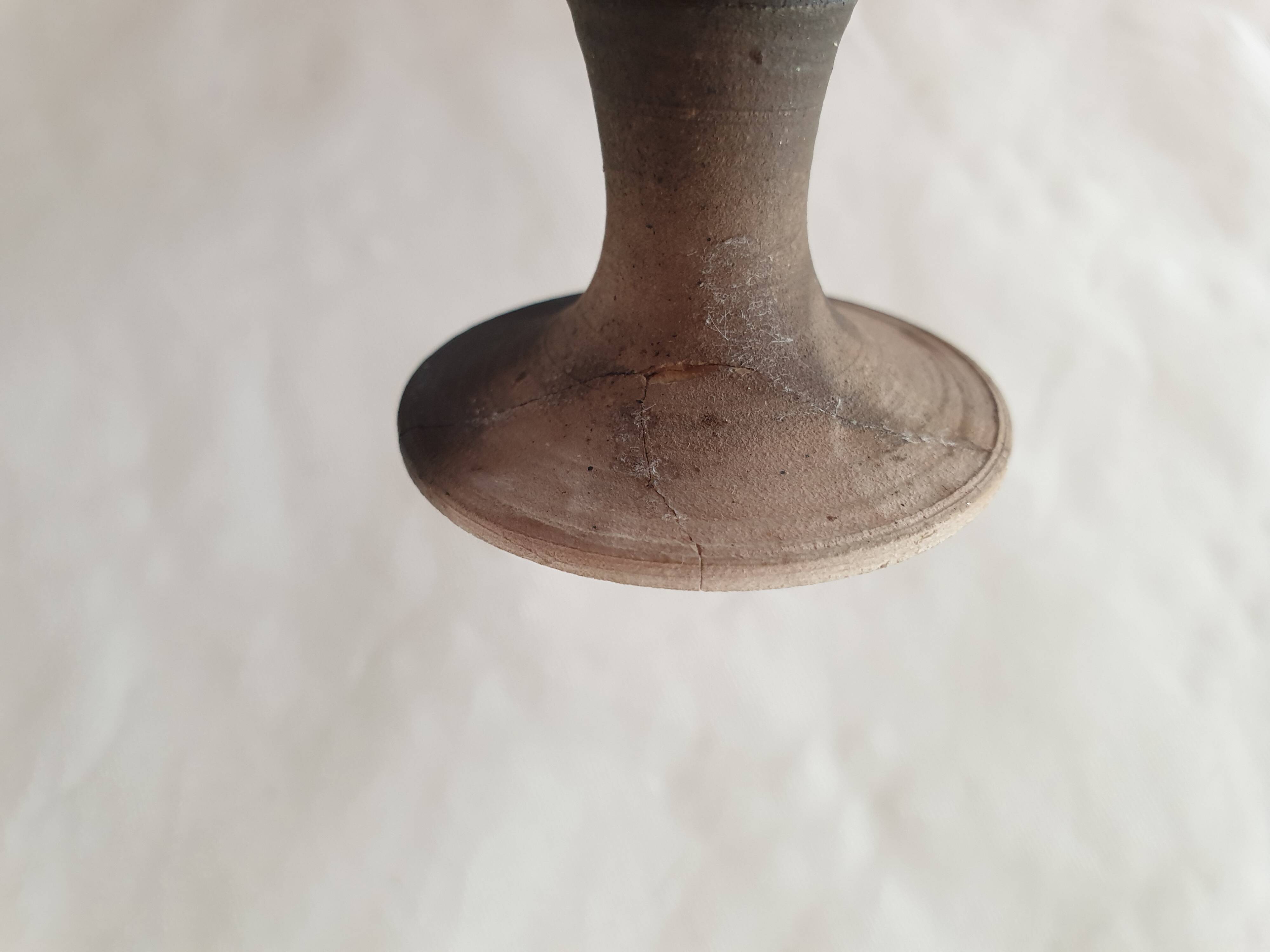 Green pot-bellied ceramic vase with foot and high, narrow neck in signed raku