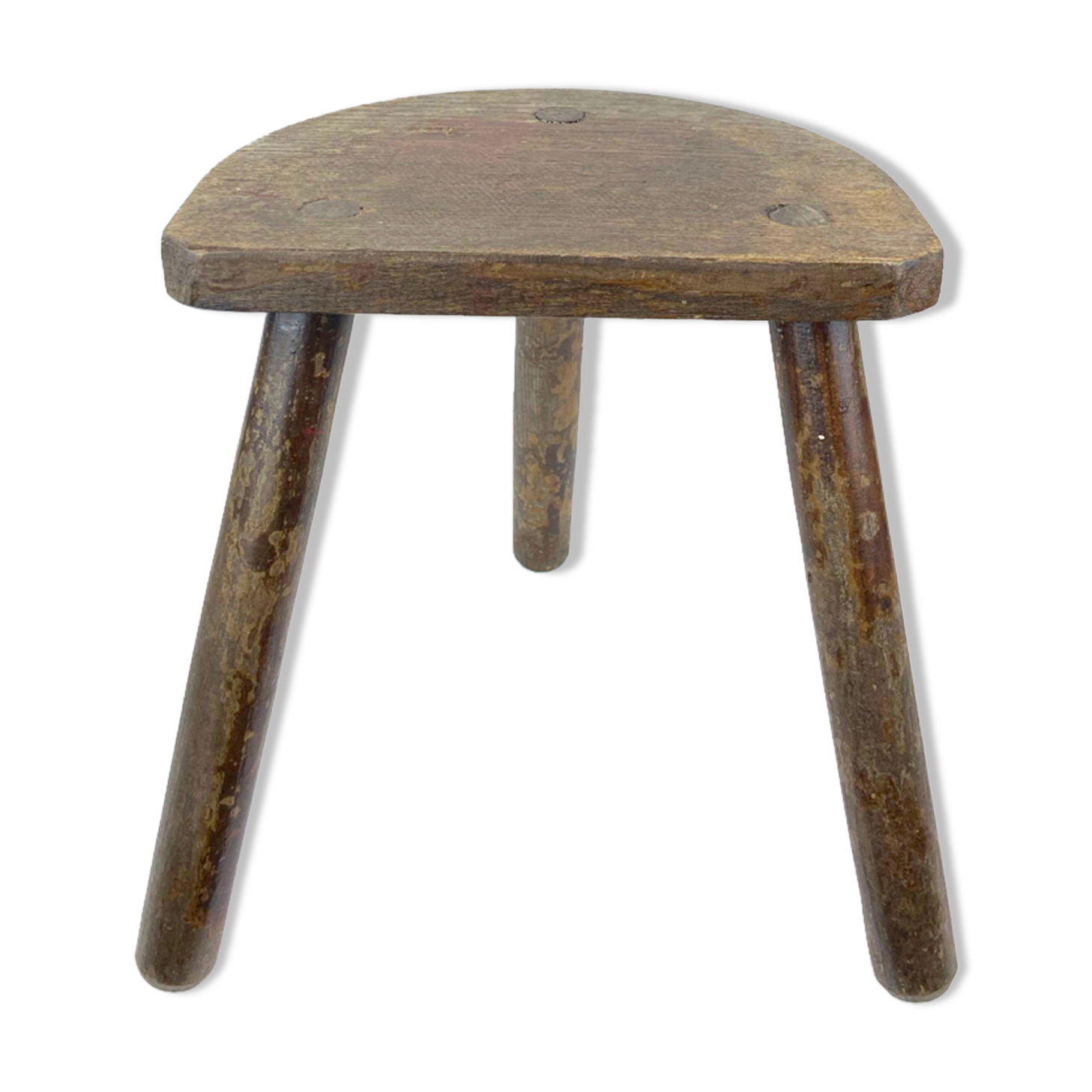 Ancient tripod milking stool - field theme, nature