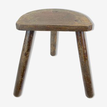 Ancient tripod milking stool - field theme, nature