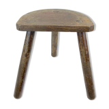 Ancient tripod milking stool - field theme, nature