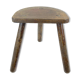 Ancient tripod milking stool - field theme, nature