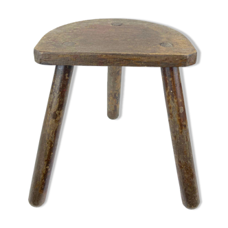 Ancient tripod milking stool - field theme, nature