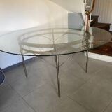 Round table with glass top and ornate metal base