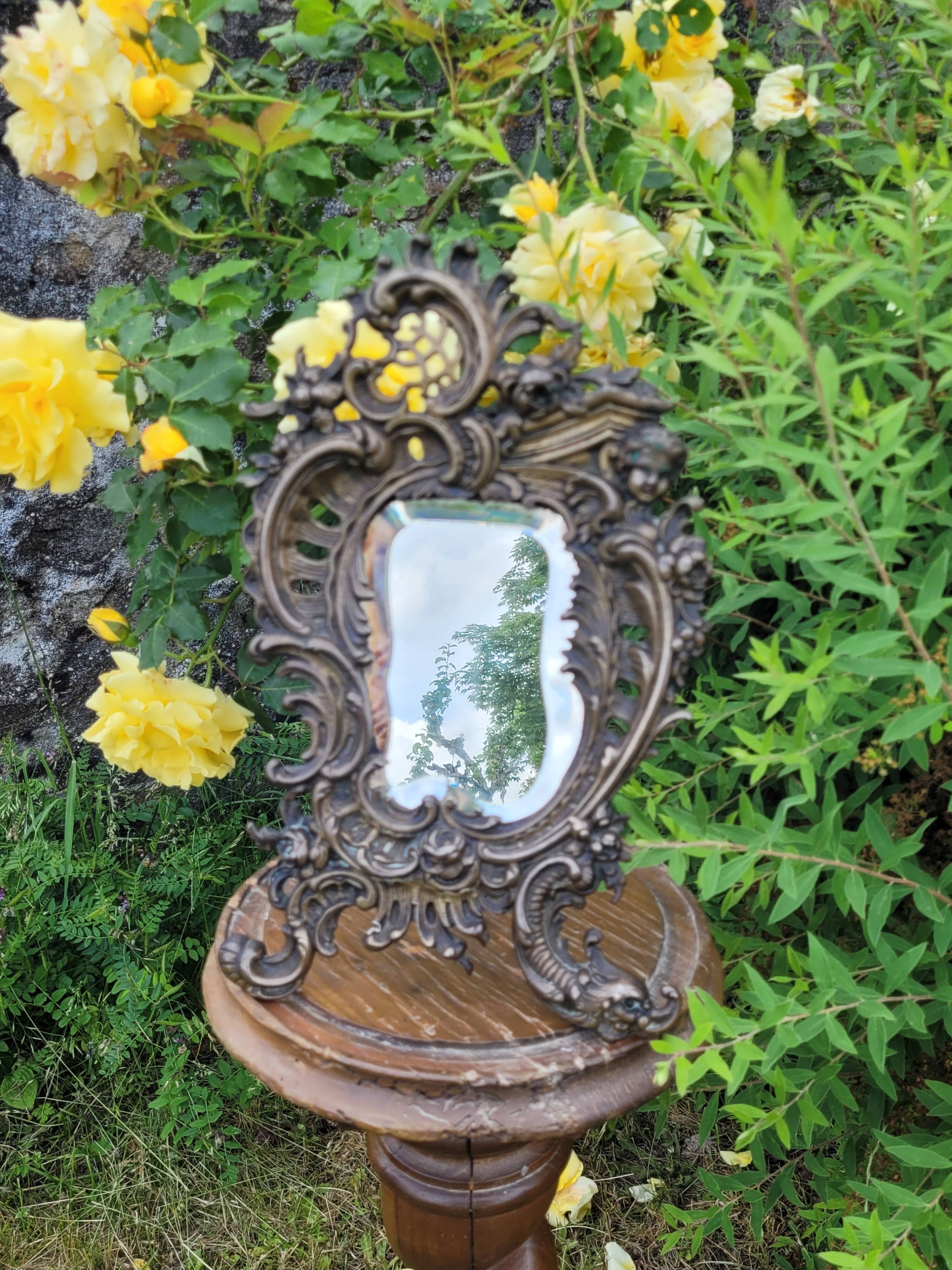 Antique bevelled bronze table mirror on stand, late 19th century.
