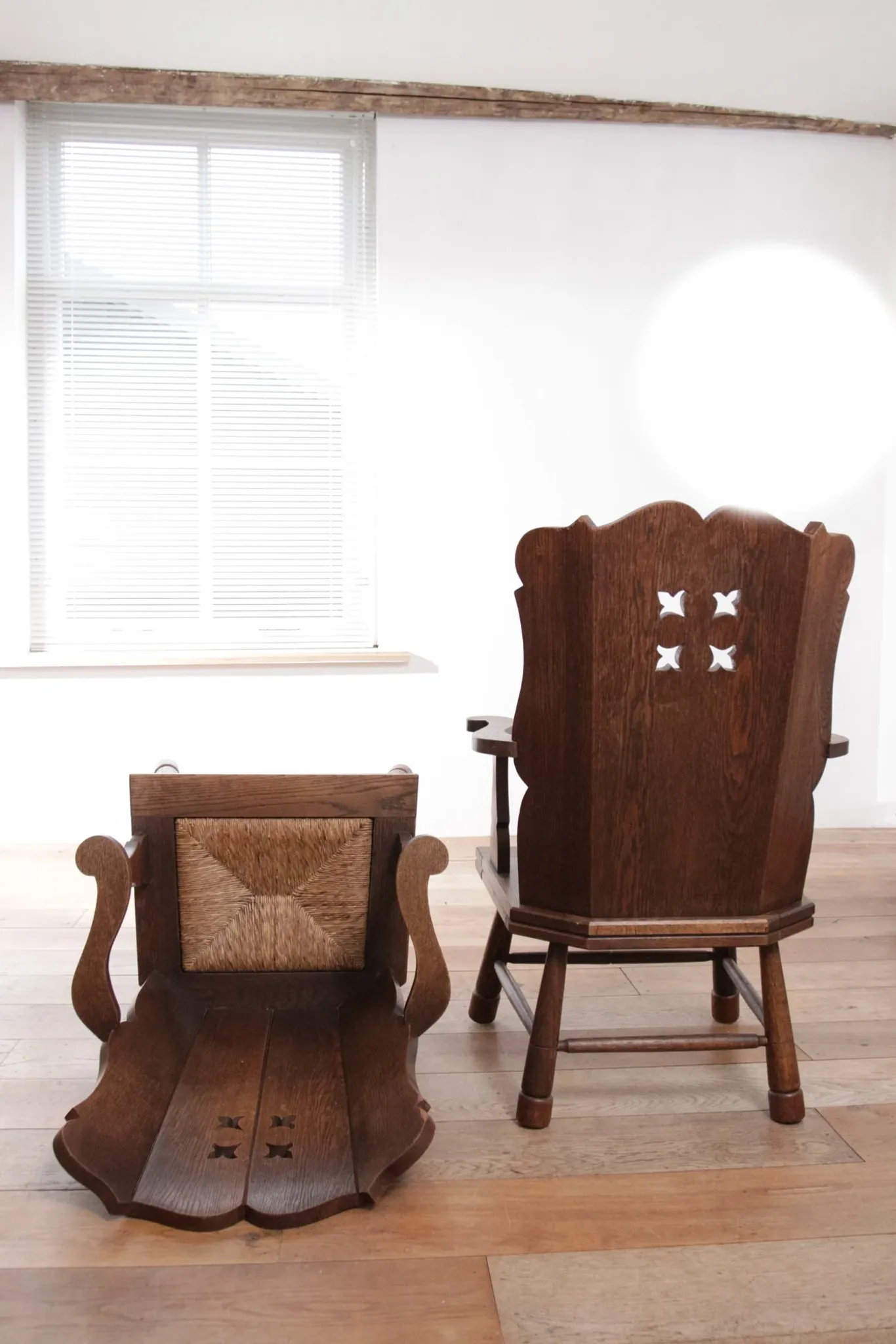 Pair of brutalist oak lounge chairs with rush seats, circa 1935