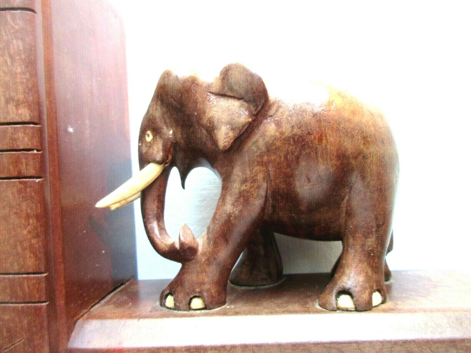 Art Deco bookends wooden elephants and bones on wooden terrace, book shape