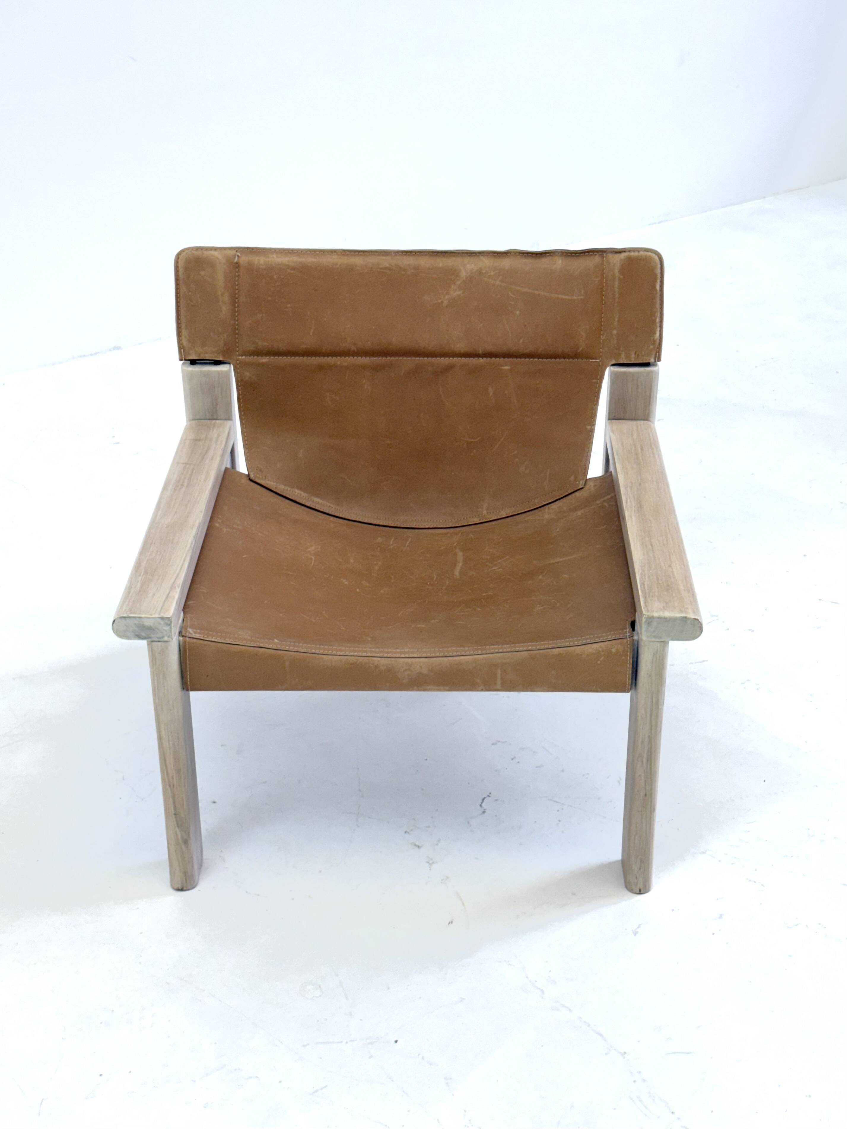 Stylish vintage armchair with saddle leather seat
