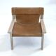 Stylish vintage armchair with saddle leather seat