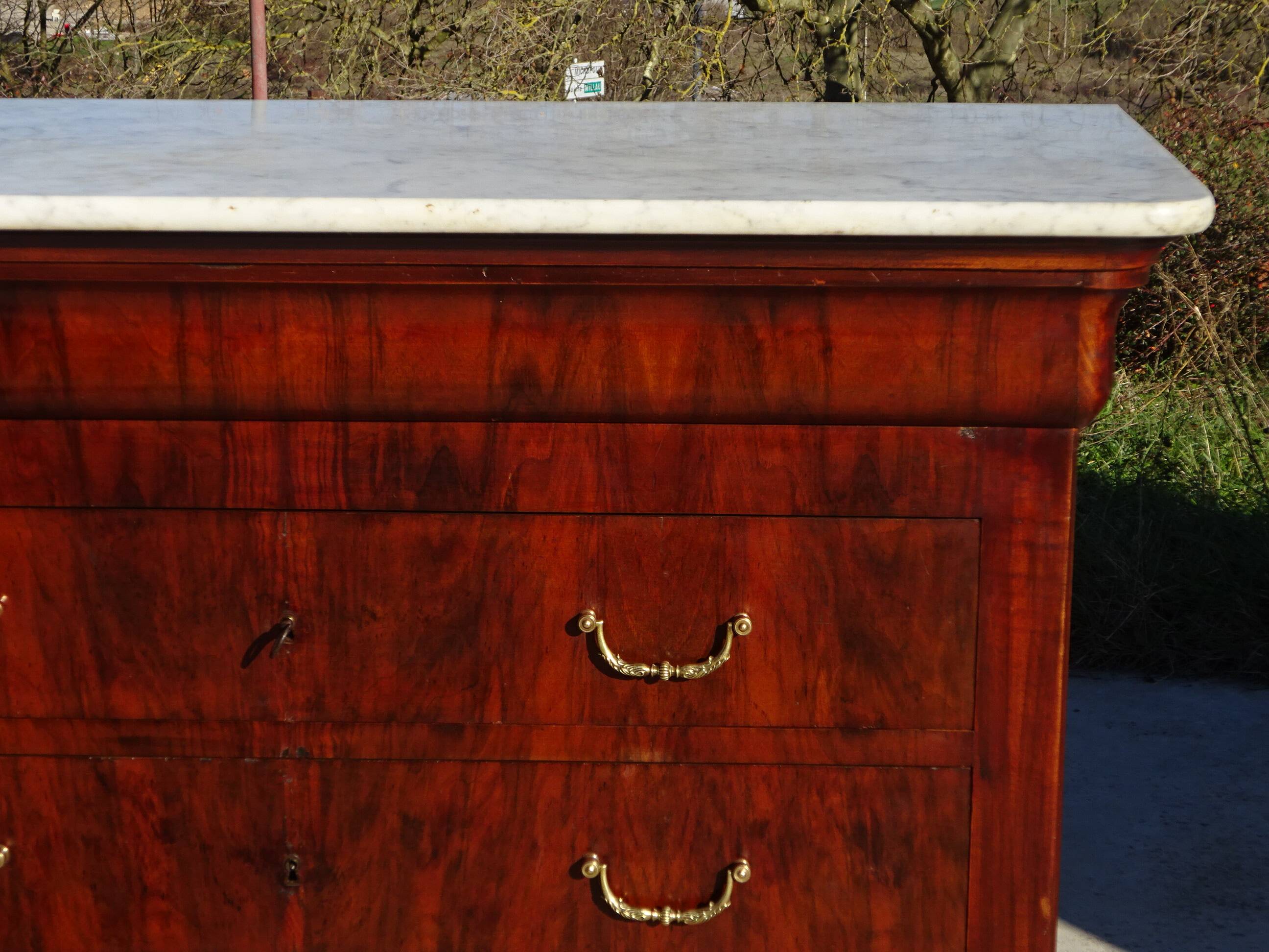 Antique mahogany chest of drawers with white marble.