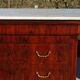 Antique mahogany chest of drawers with white marble.