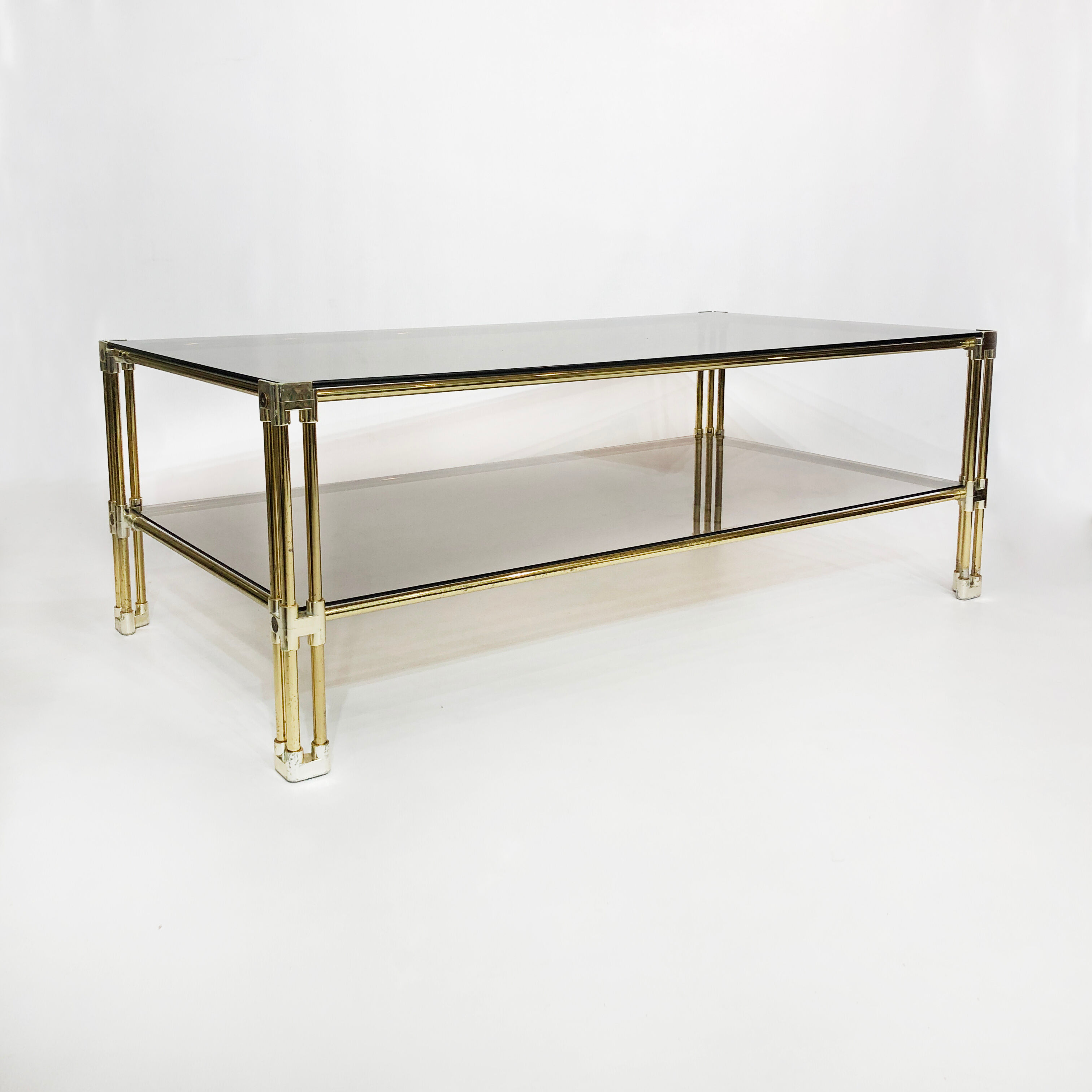 Brass two-tiered coffee table hollywood regency gold smoked glass 1970s
