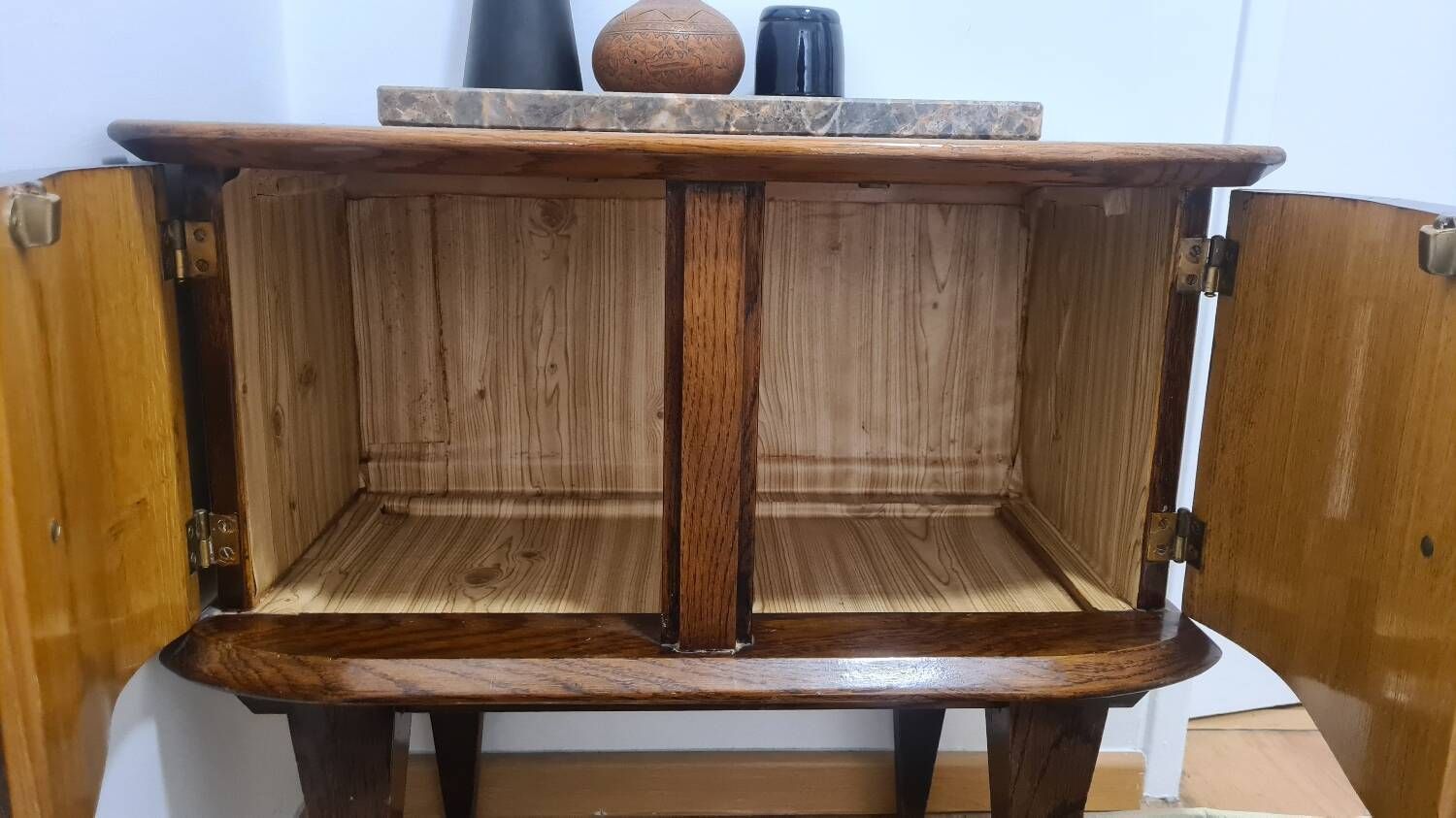 Small vintage 1950s wooden buffet with marble top and tapered legs.