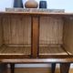 Small vintage 1950s wooden buffet with marble top and tapered legs.