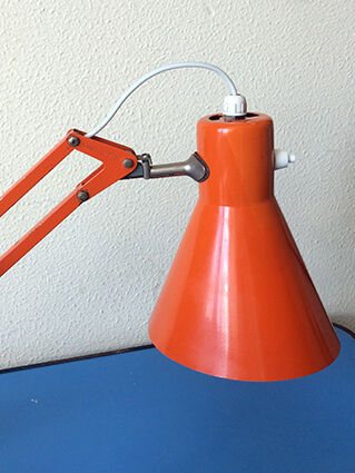 Luxo L9 orange single-arm lamp on plinth