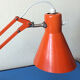 Luxo L9 orange single-arm lamp on plinth