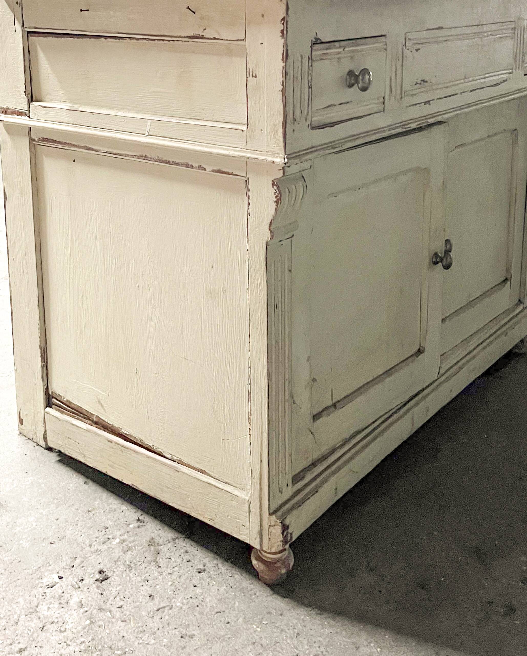 Antique wooden bathroom cabinet with painted finish and white marble.