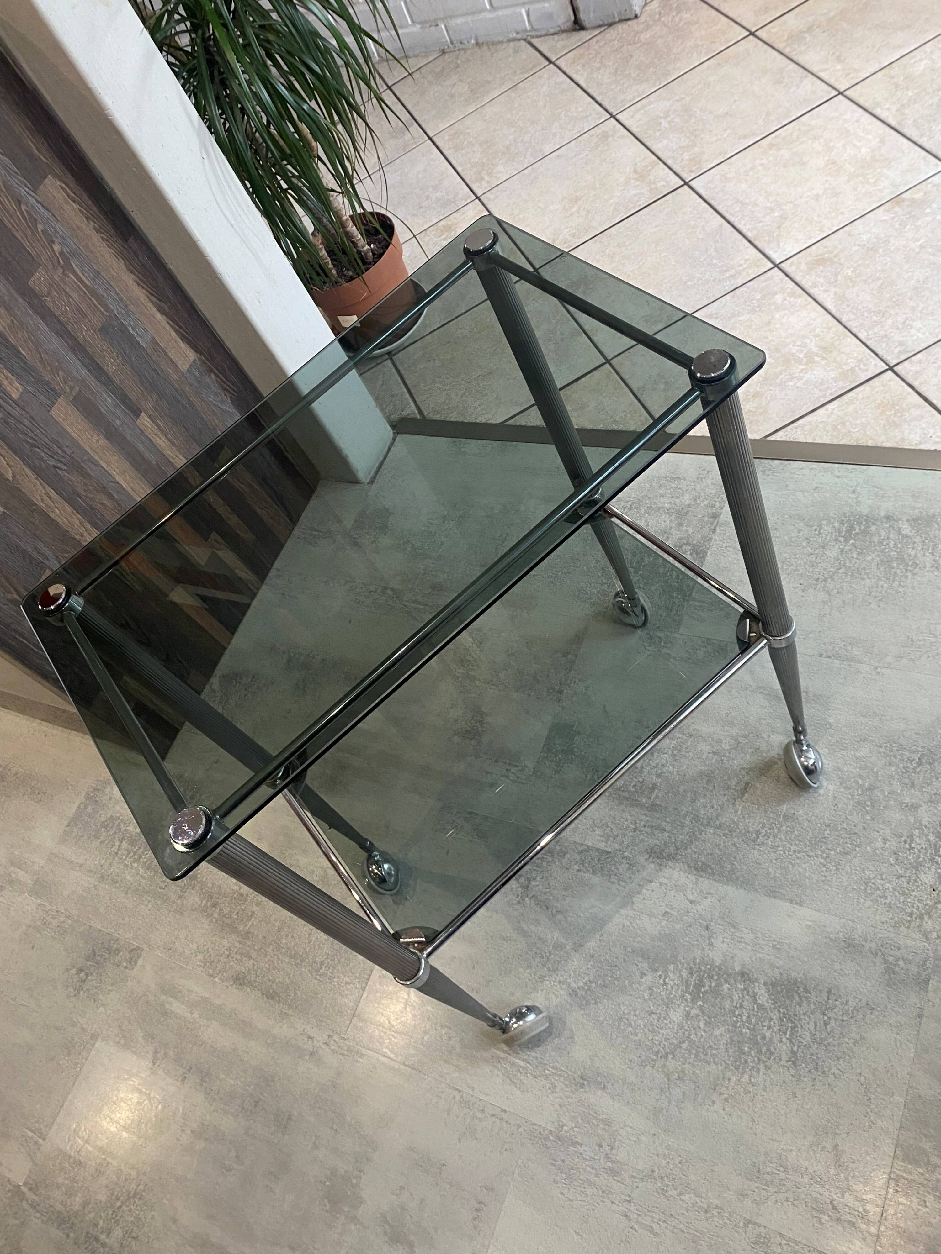 Serving dessert trolley with 2 smoked glass shelves and metal structure.