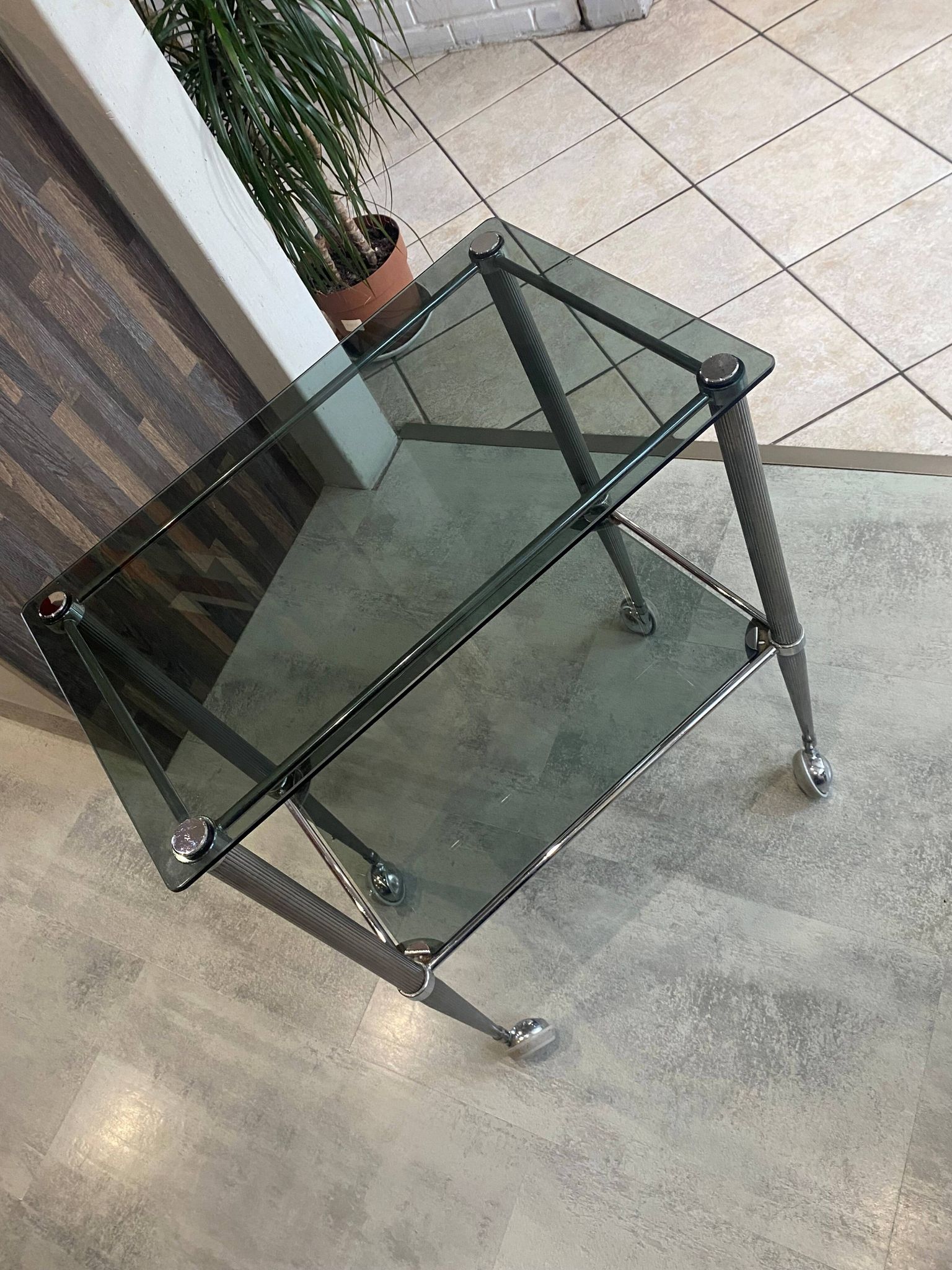 Serving dessert trolley with 2 smoked glass shelves and metal structure.
