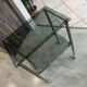 Serving dessert trolley with 2 smoked glass shelves and metal structure.
