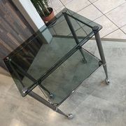 Serving dessert trolley with 2 smoked glass shelves and metal structure.