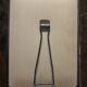Simple rectangular barber mirror with a stand.