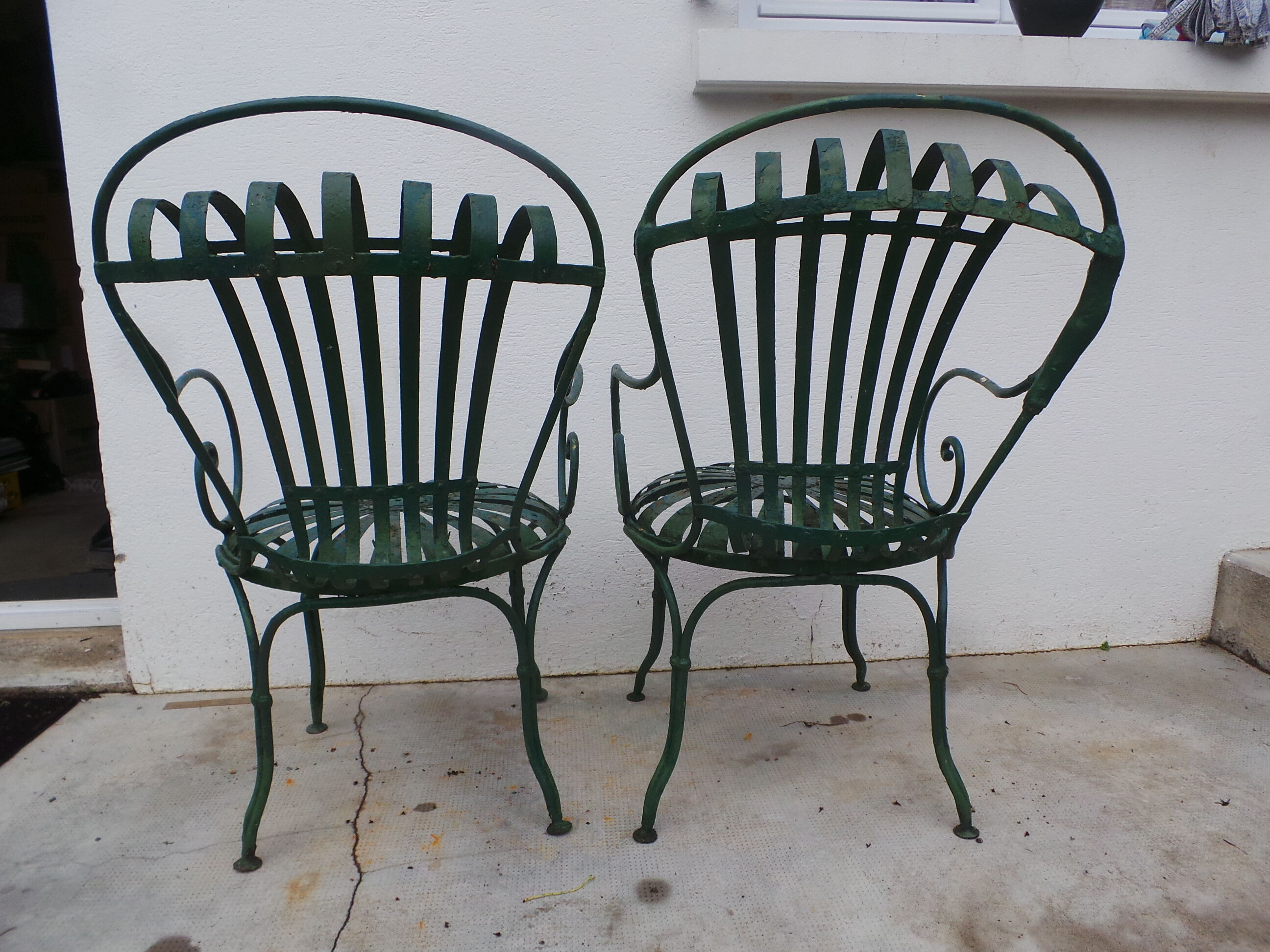 Pair of wrought iron garden chairs by François Carre