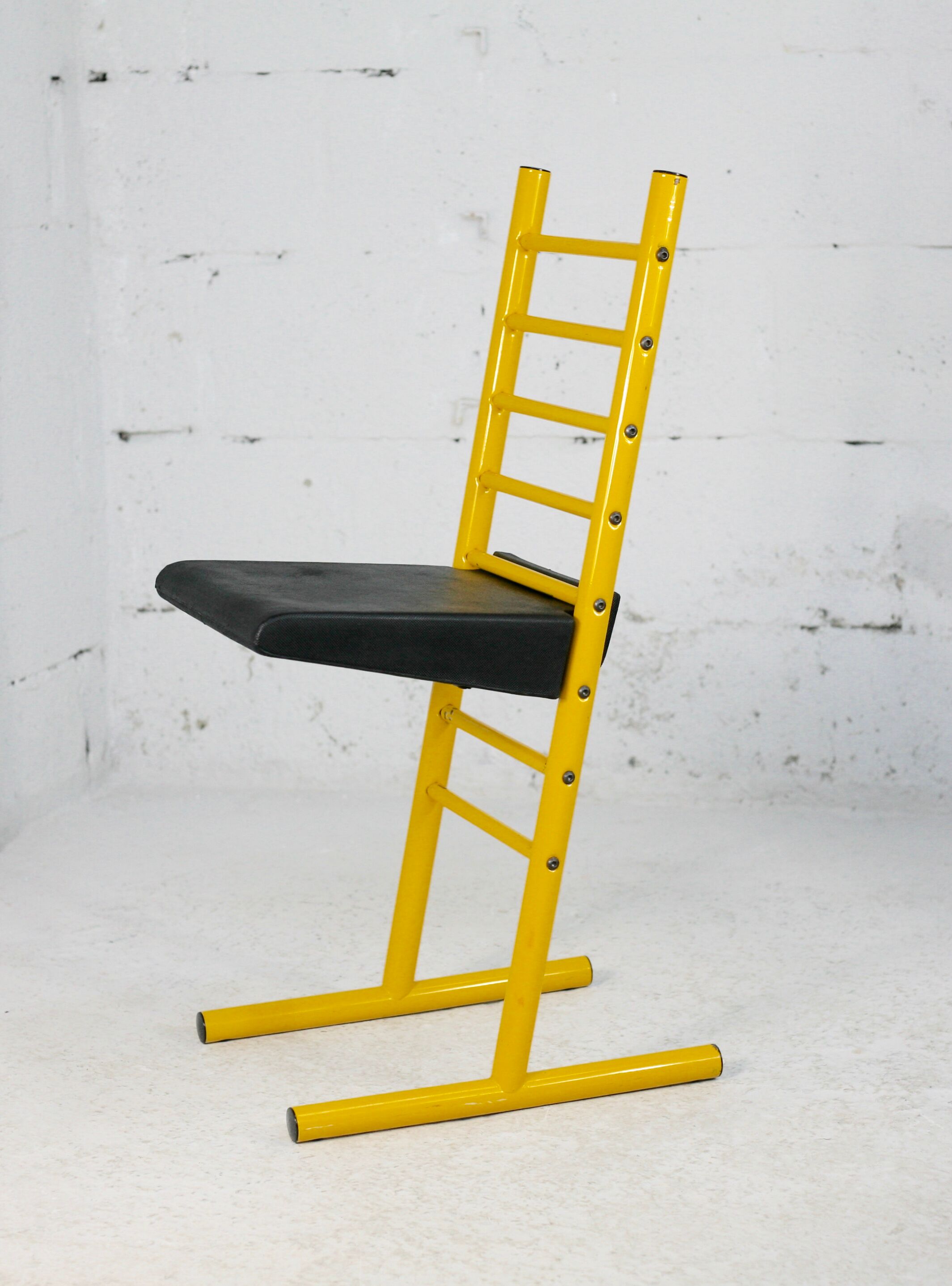 Adjustable seat chair. Circa 1980. Italy. Yellow lacquered steel.