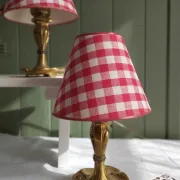 Pair of small lamps in gilded bronze by Petitot and red gingham lampshades.