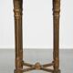 Antique French round side table in golden colour with a marble top.