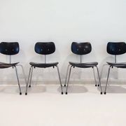 Set of four Egon Eiermann model SE 68 chairs in black lacquered plywood and steel.