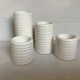 Four white earthenware candle holders