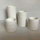 Four white earthenware candle holders