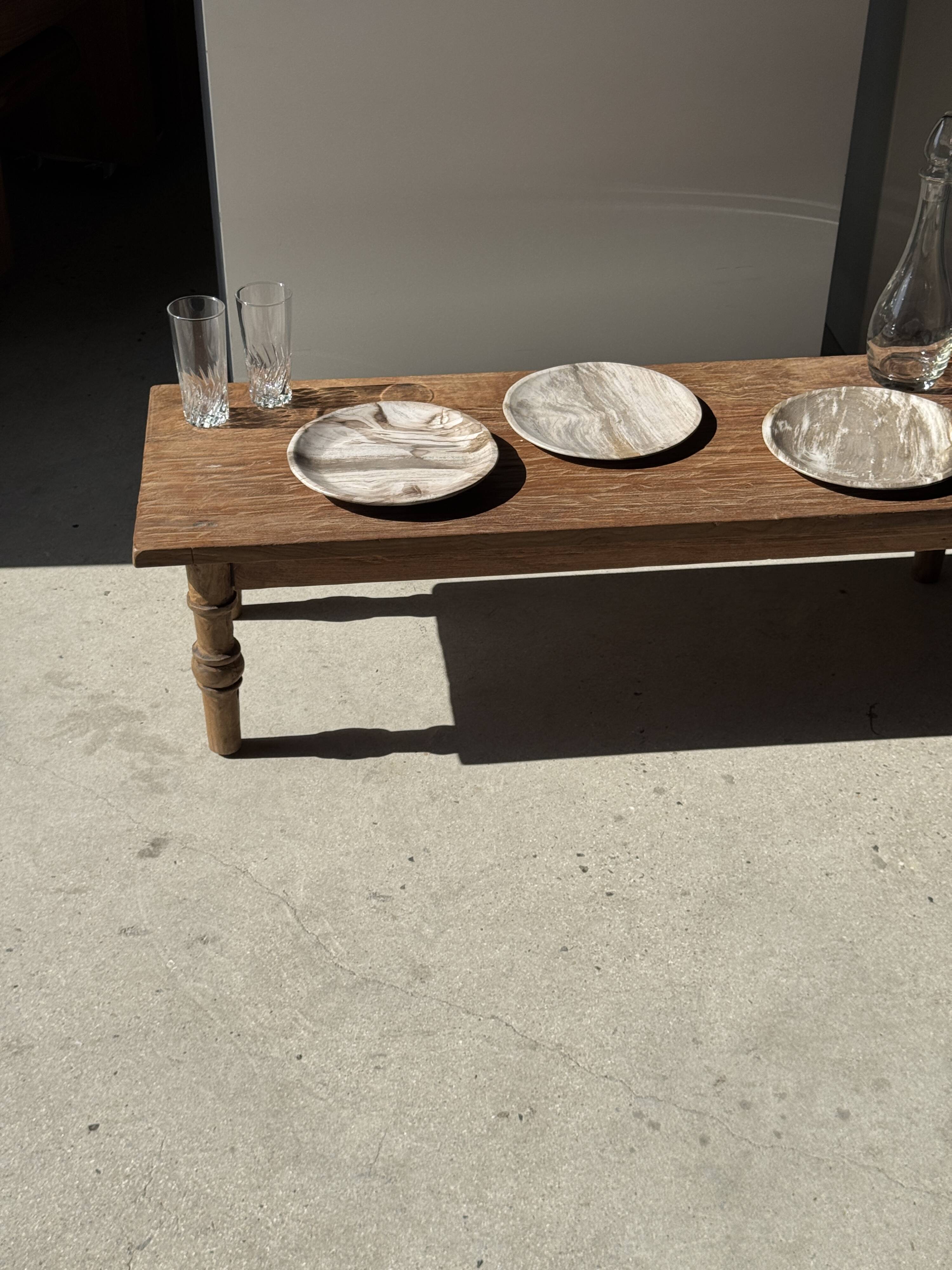 Tray, circular dish or plate made of white striped grey petrified wood.