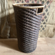 High basket in braided wicker