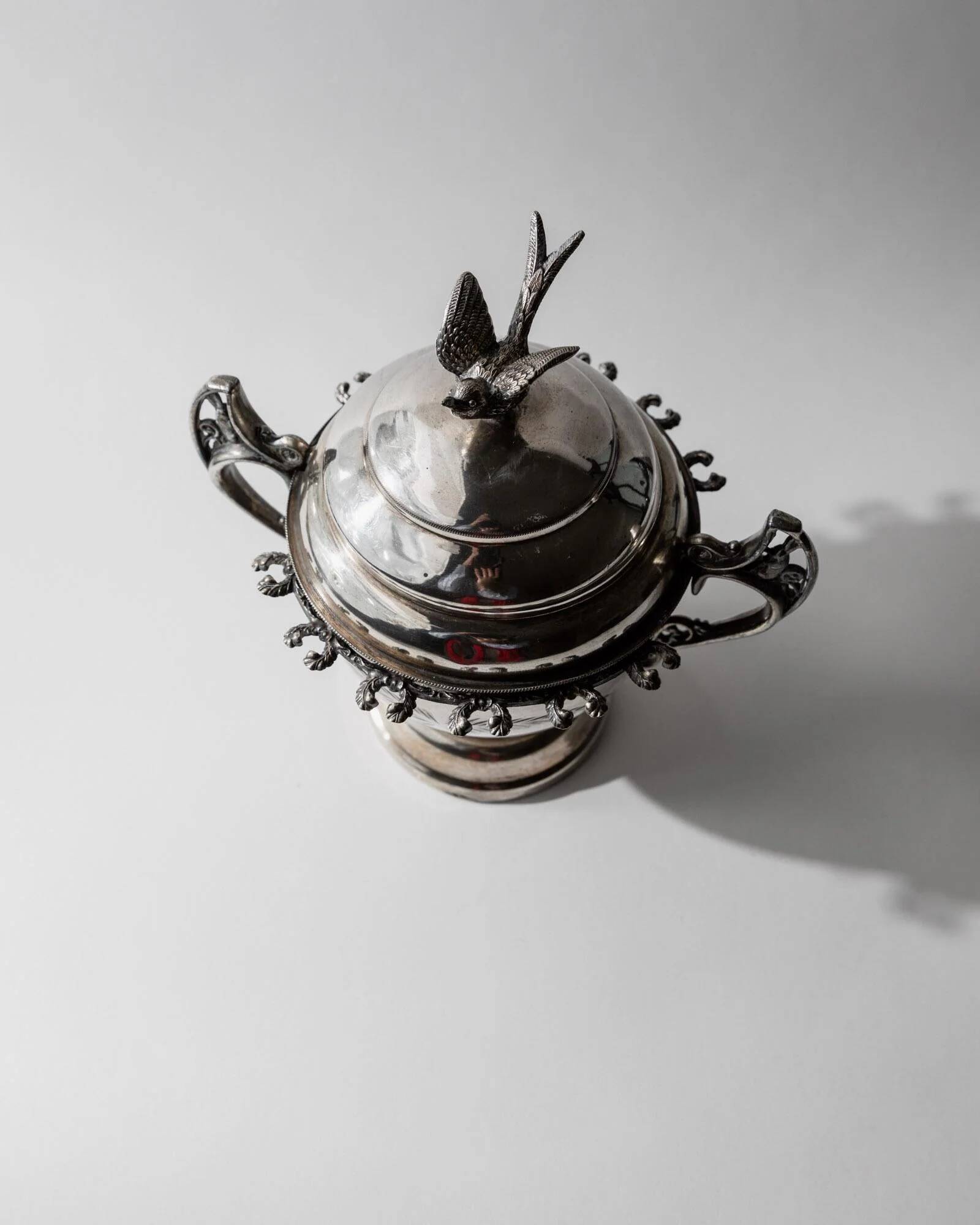 Vintage 1930s silver-plated footed bowl with lid by Warren Rogers New York, featuring a bird motif and ornate details.