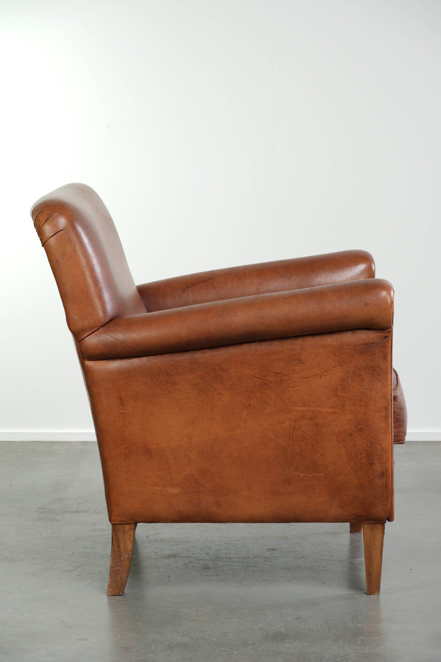 Sturdy vintage sheepskin armchair with a beautiful cognac colour