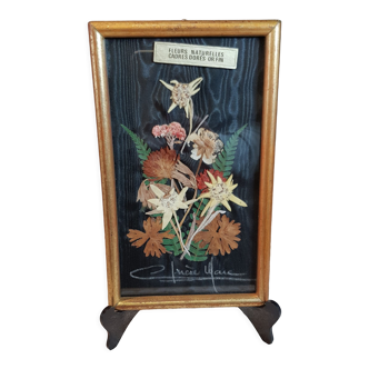 Gold-covered frame with dried flowers