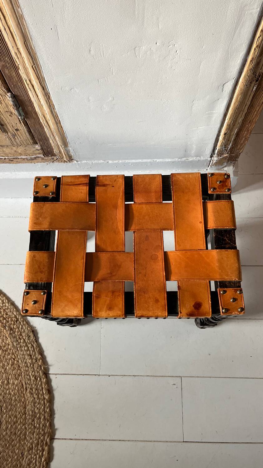 Antique turned wooden stool with woven leather.