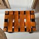 Antique turned wooden stool with woven leather.