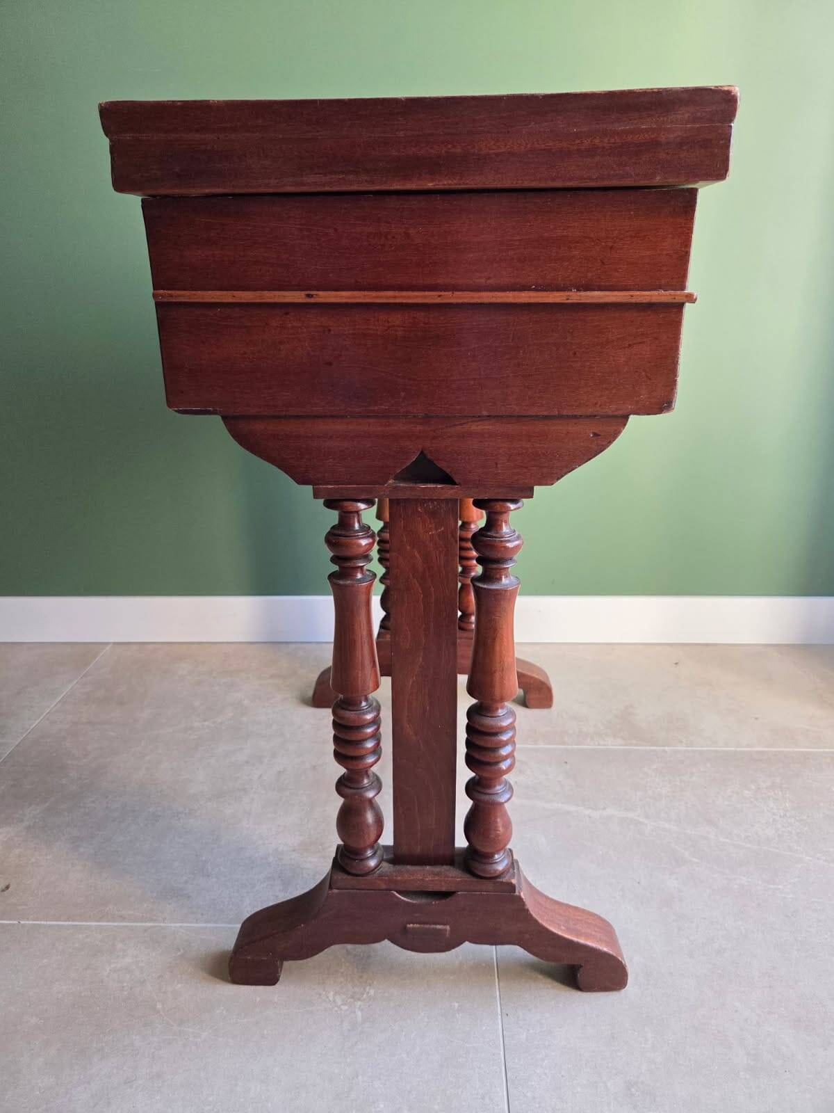 Antique wooden sewing cabinet with mirror and storage.